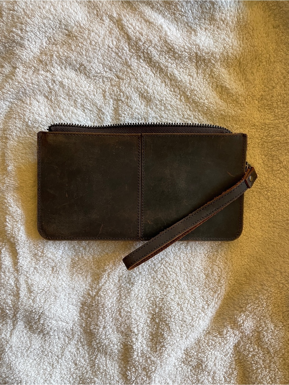 Crazy Horse brown leather clutch wallet featuring a wrist strap pockets zipper